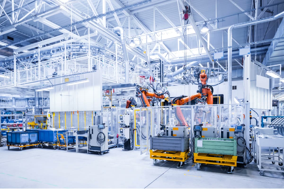 Robotic cells on a bright, modern manufacturing floor