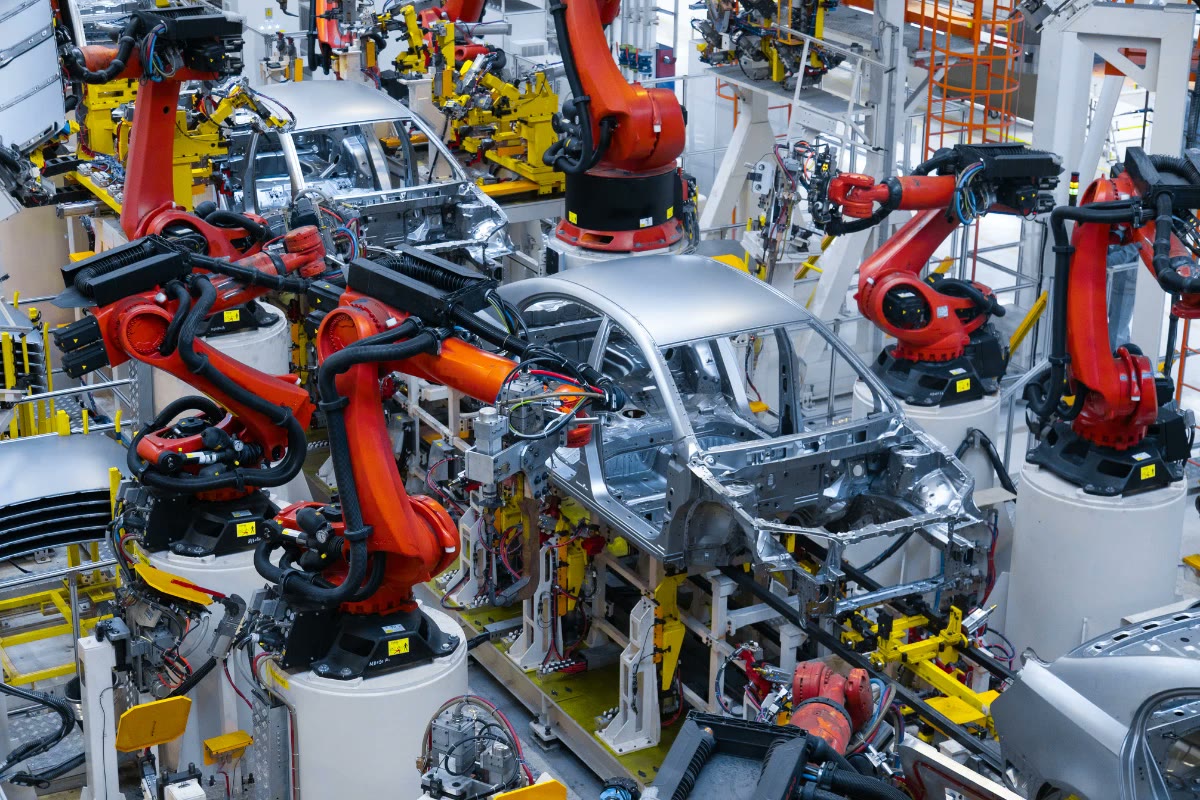 Robotic arms assembling car bodies on an automotive production line
