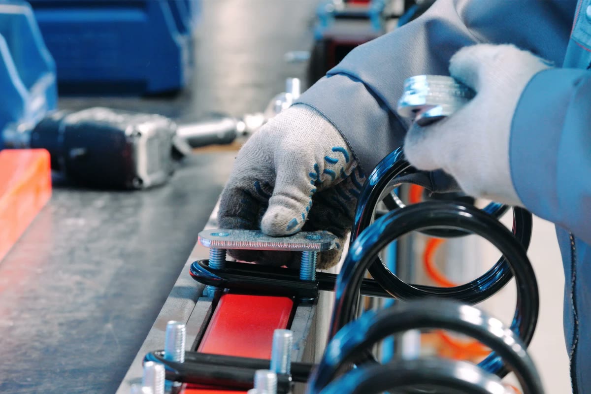 Worker assembling components on a production line